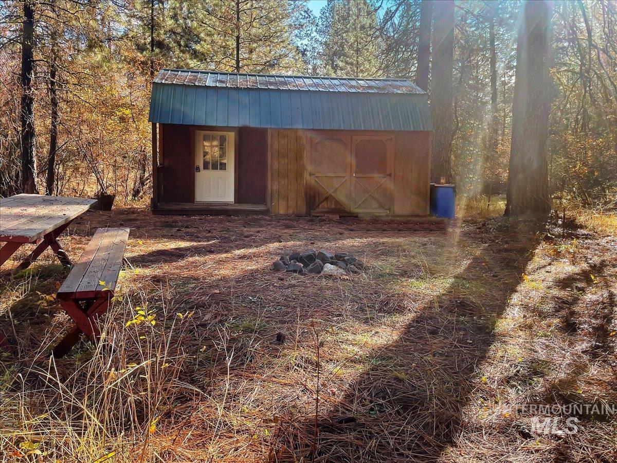 View of outbuilding with a wooded view