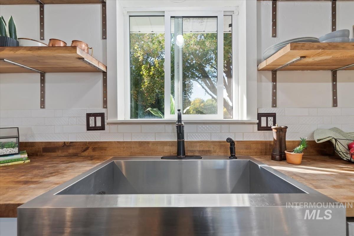 Kitchen view of wood counters and tasteful backsplash