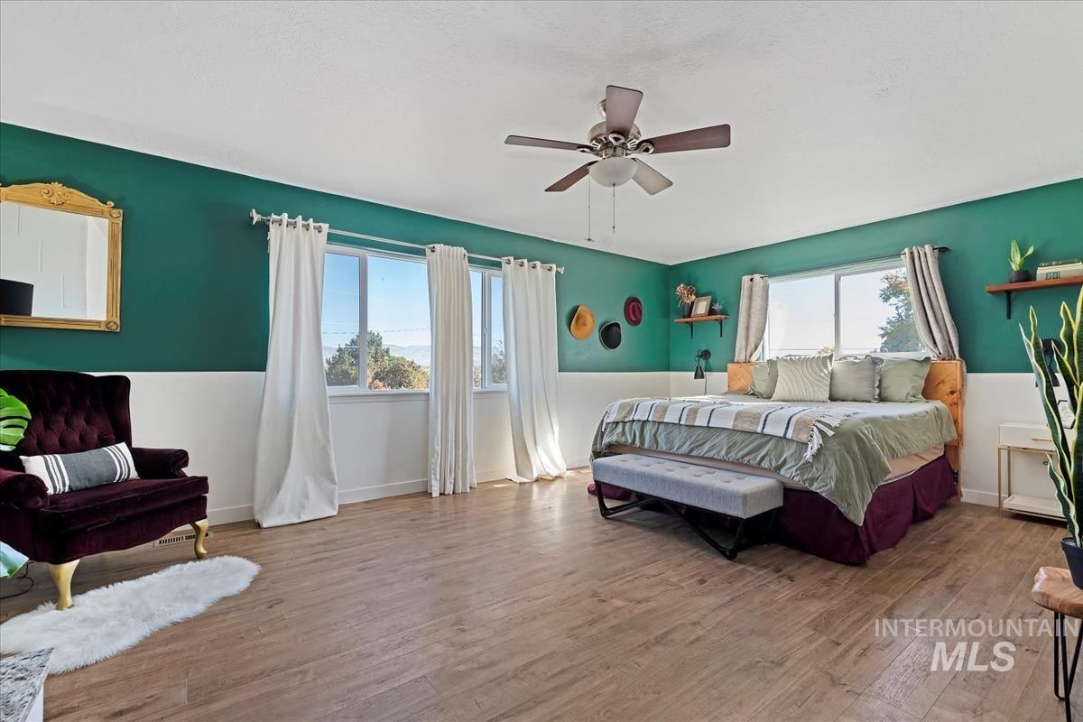 Bedroom with wood finished floors and a ceiling fan