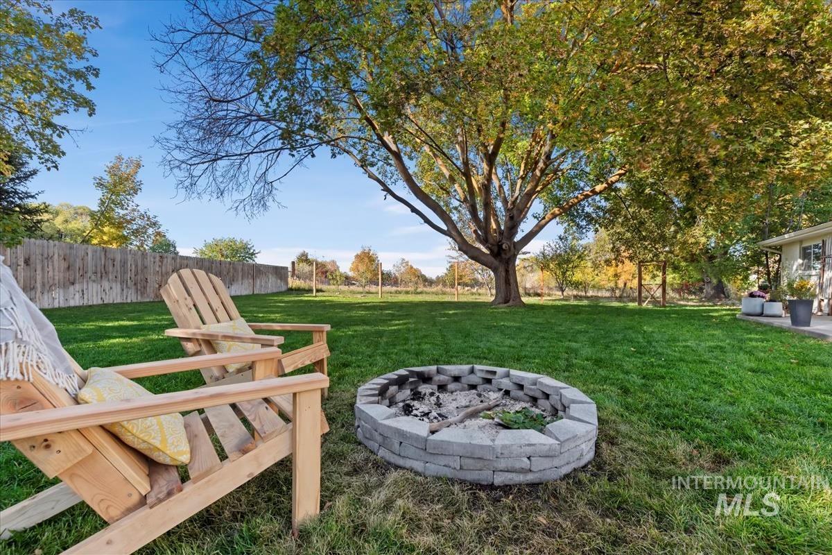 View of yard with a fire pit and a patio area