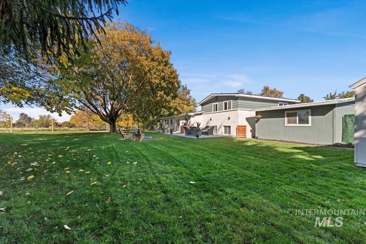 View of green lawn with a patio area