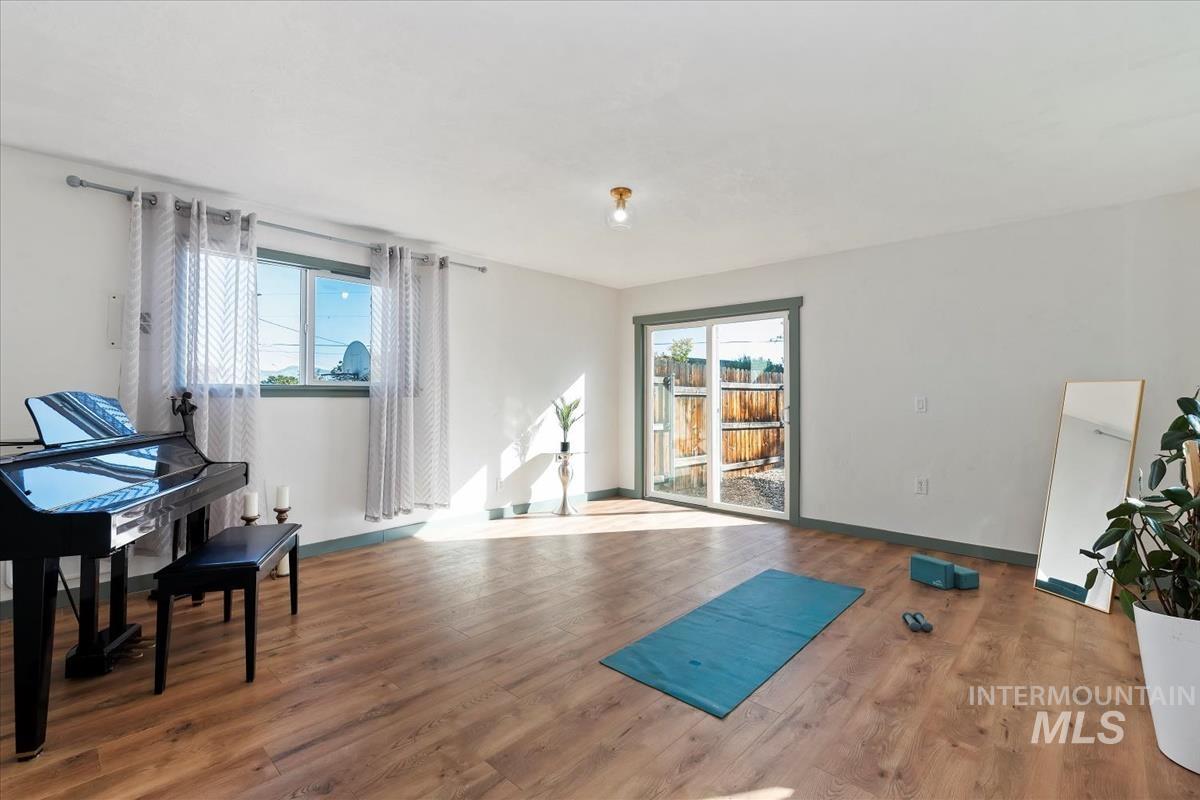 Workout room featuring wood finished floors