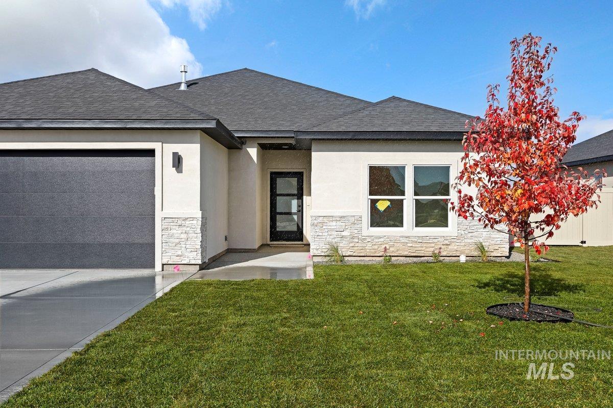 View of front facade with stone siding, stucco siding, and a front lawn