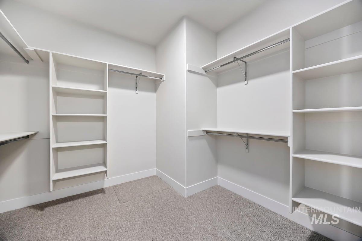 Spacious closet with light colored carpet