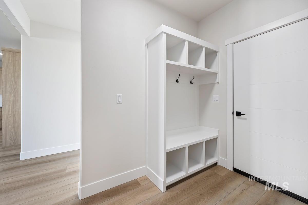 Mudroom with baseboards and light wood finished floors