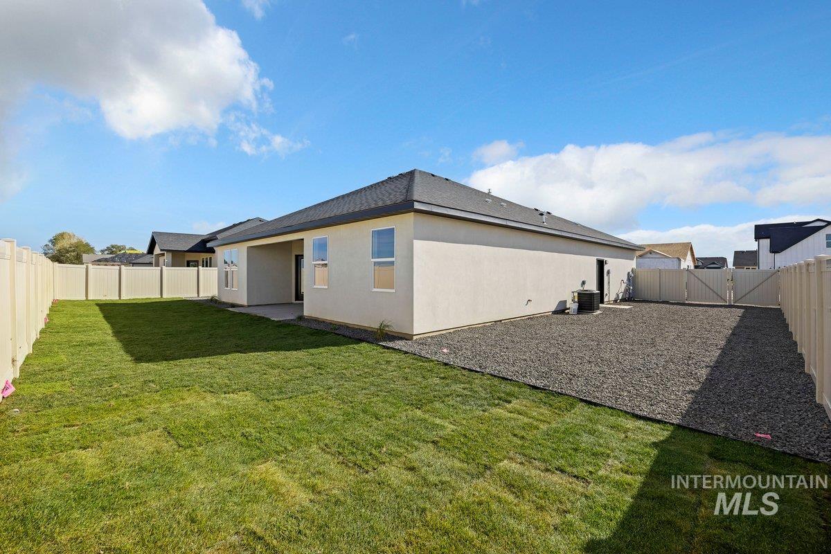 Back of house with a fenced backyard, a patio, stucco siding, and a shingled roof