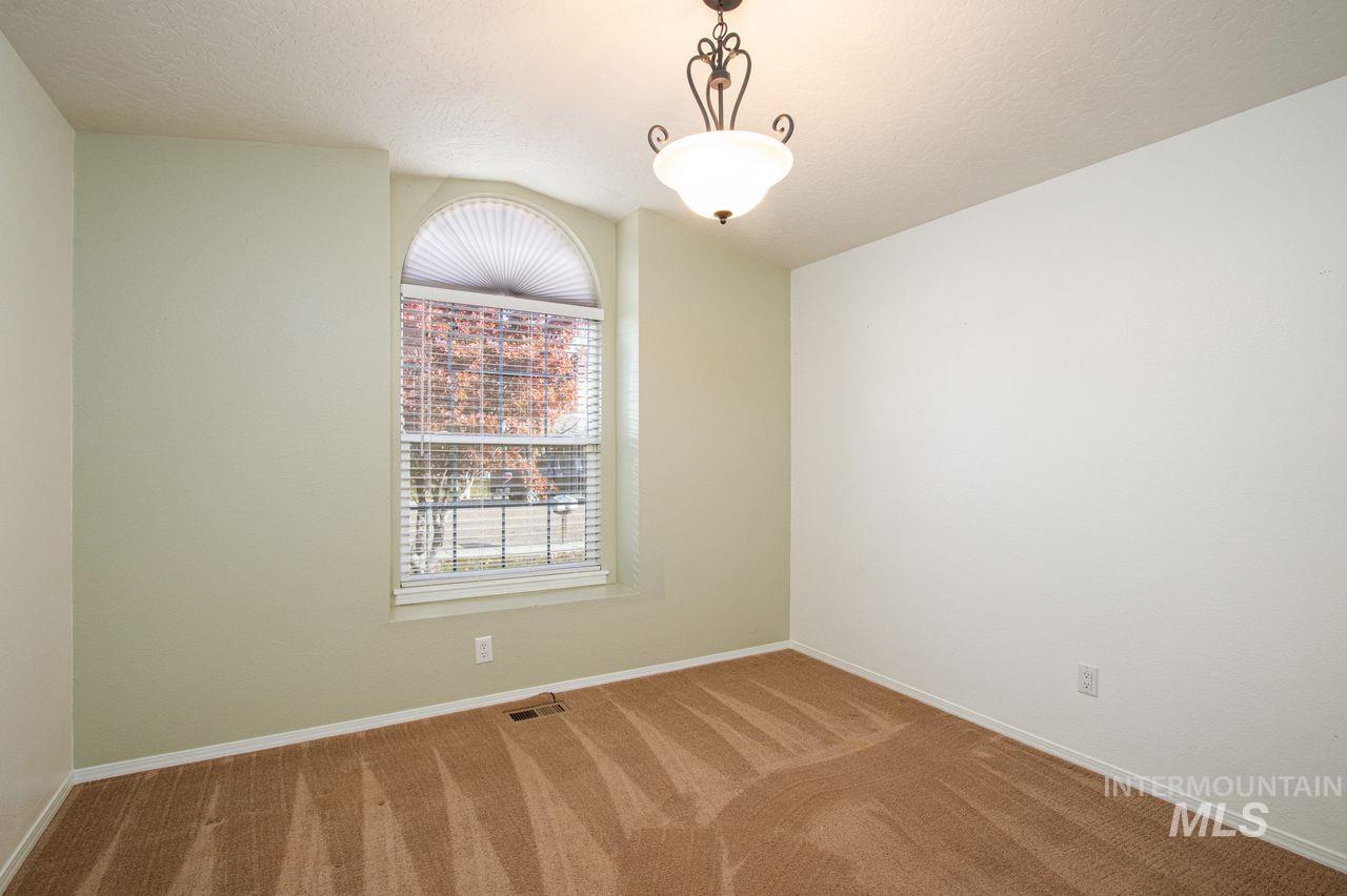 Unfurnished room with carpet and a textured ceiling