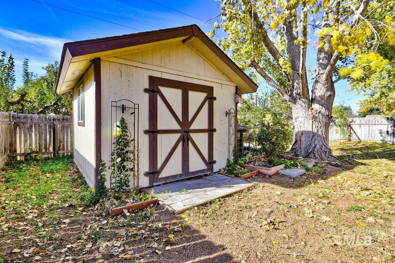 View of shed with a fenced backyard