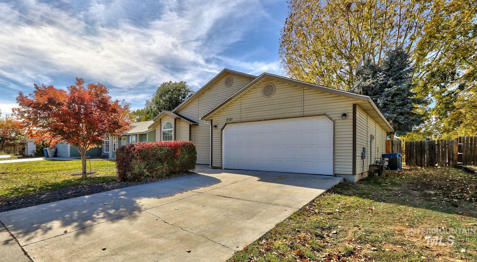 View of front facade featuring a garage and concrete driveway