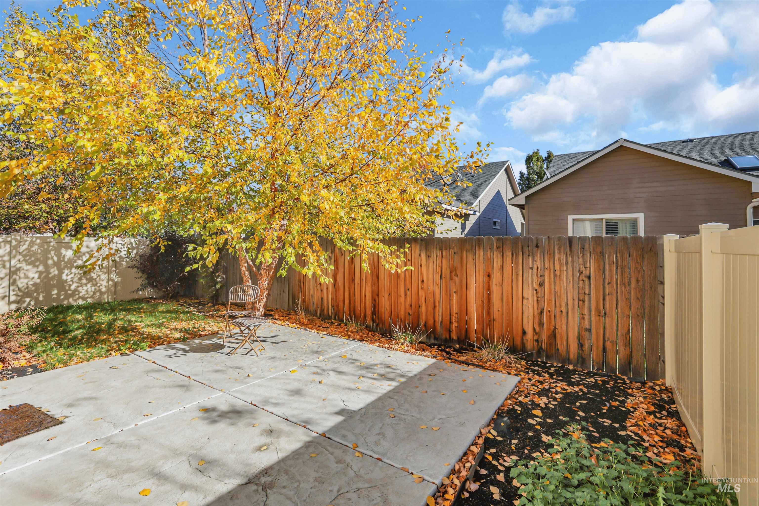 Fenced backyard with a patio