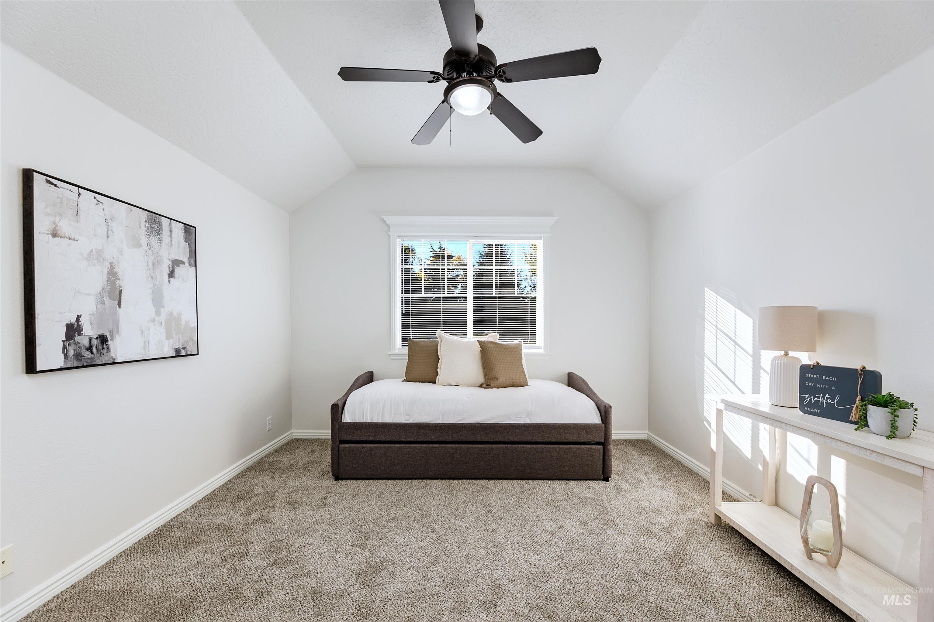 Bedroom with carpet flooring, lofted ceiling, and ceiling fan