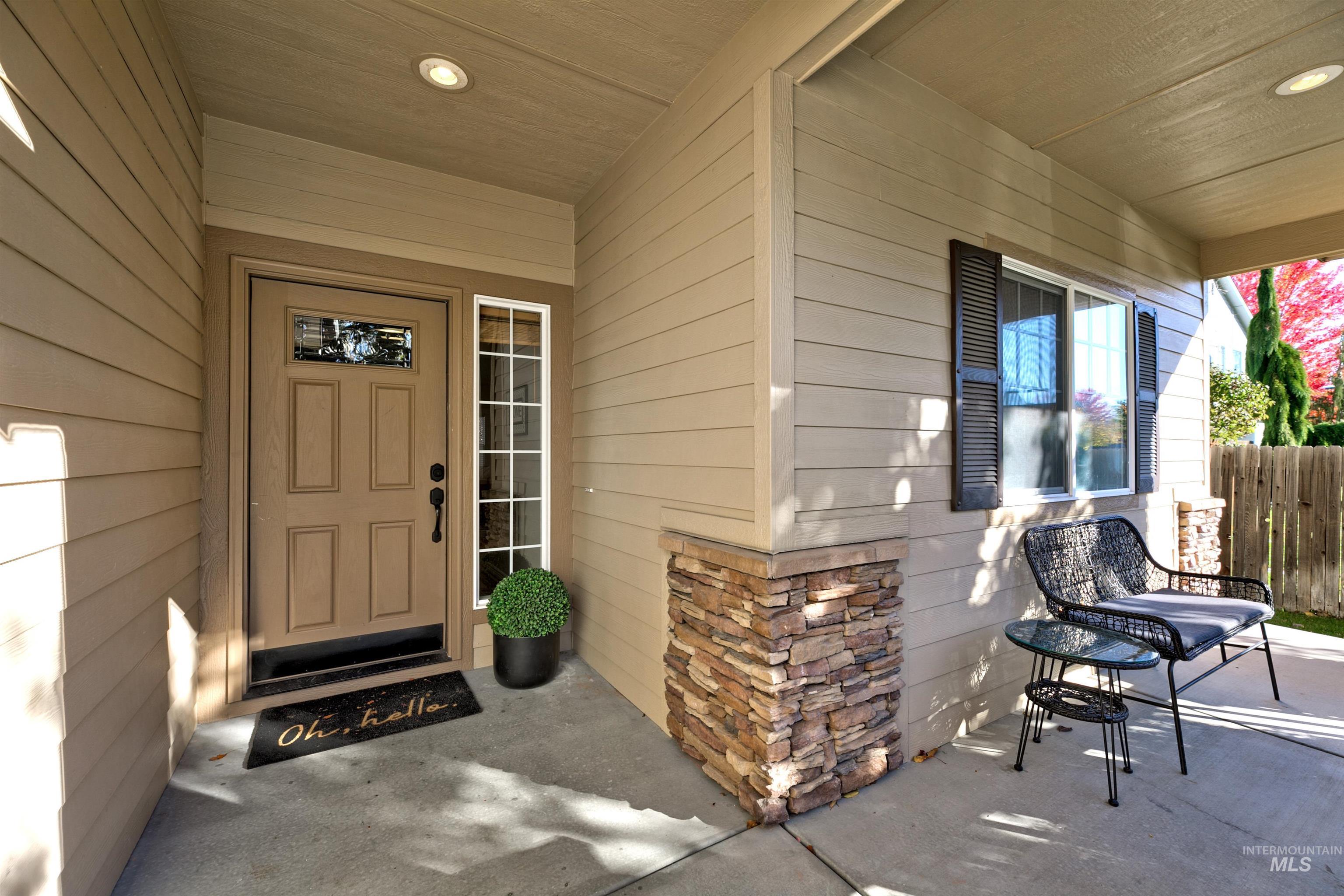 Property entrance with a porch and stone siding