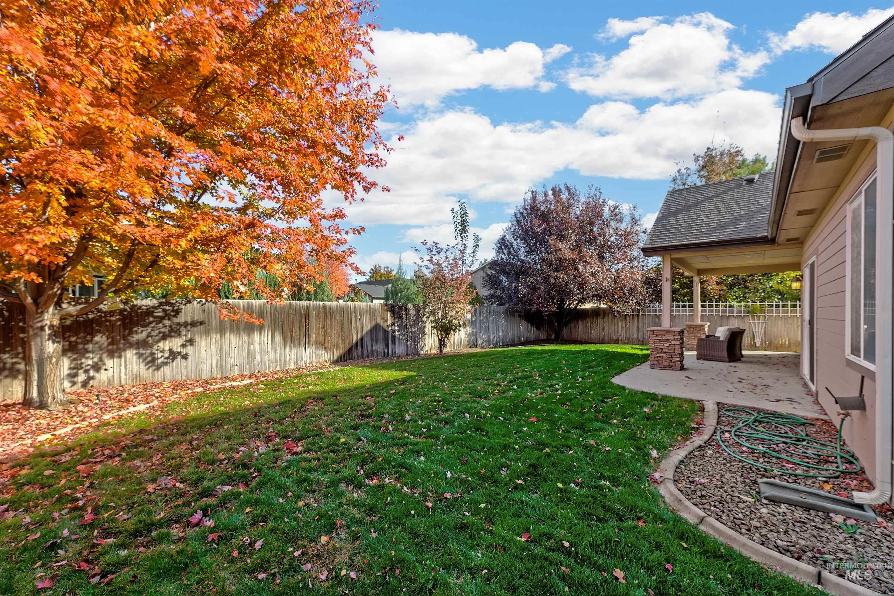 Fenced backyard featuring a patio