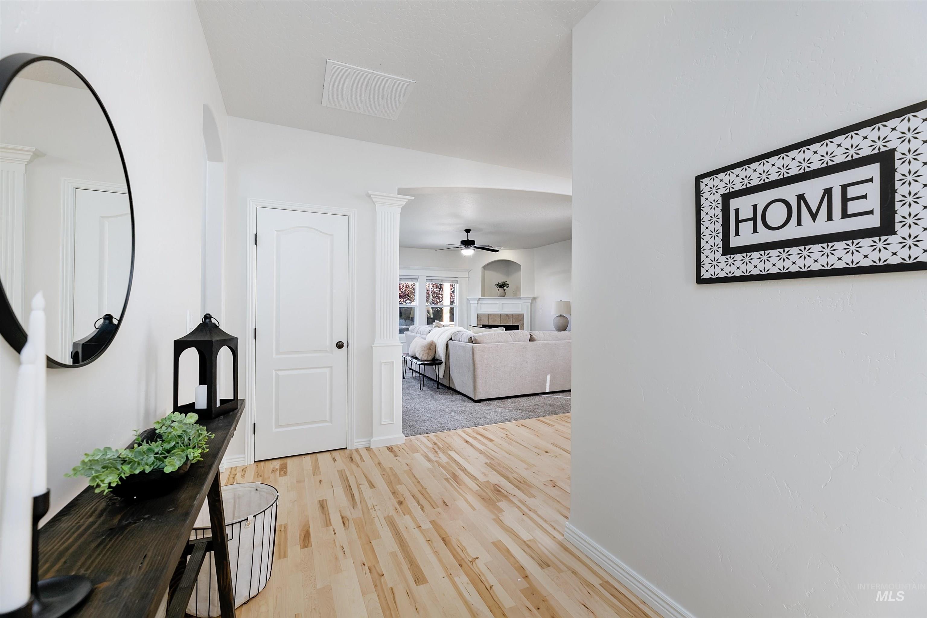 Corridor with light wood-style floors and baseboards