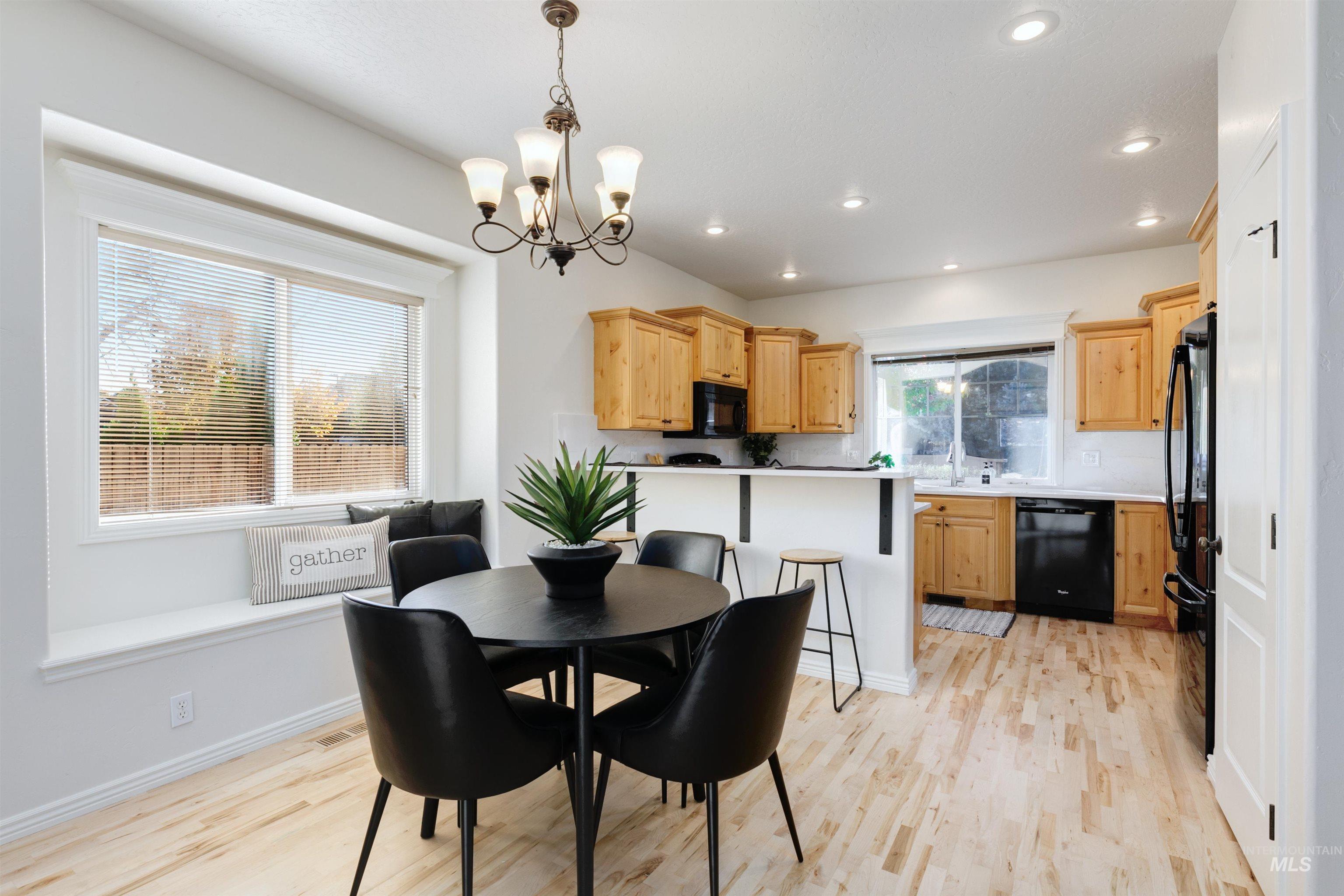 Dining room with light wood-style flooring, a chandelier, and recessed lighting