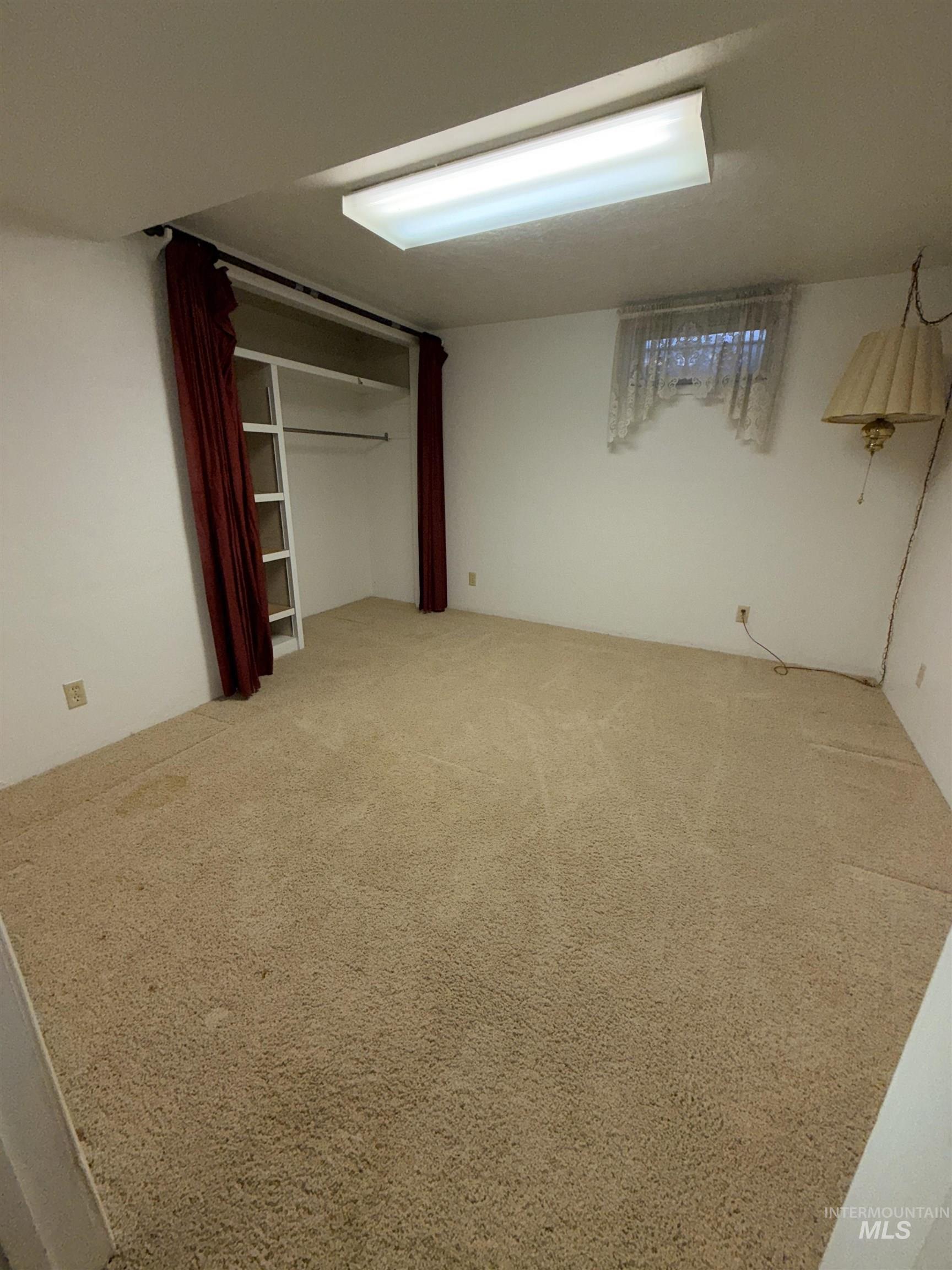 Unfurnished bedroom featuring light colored carpet and a closet