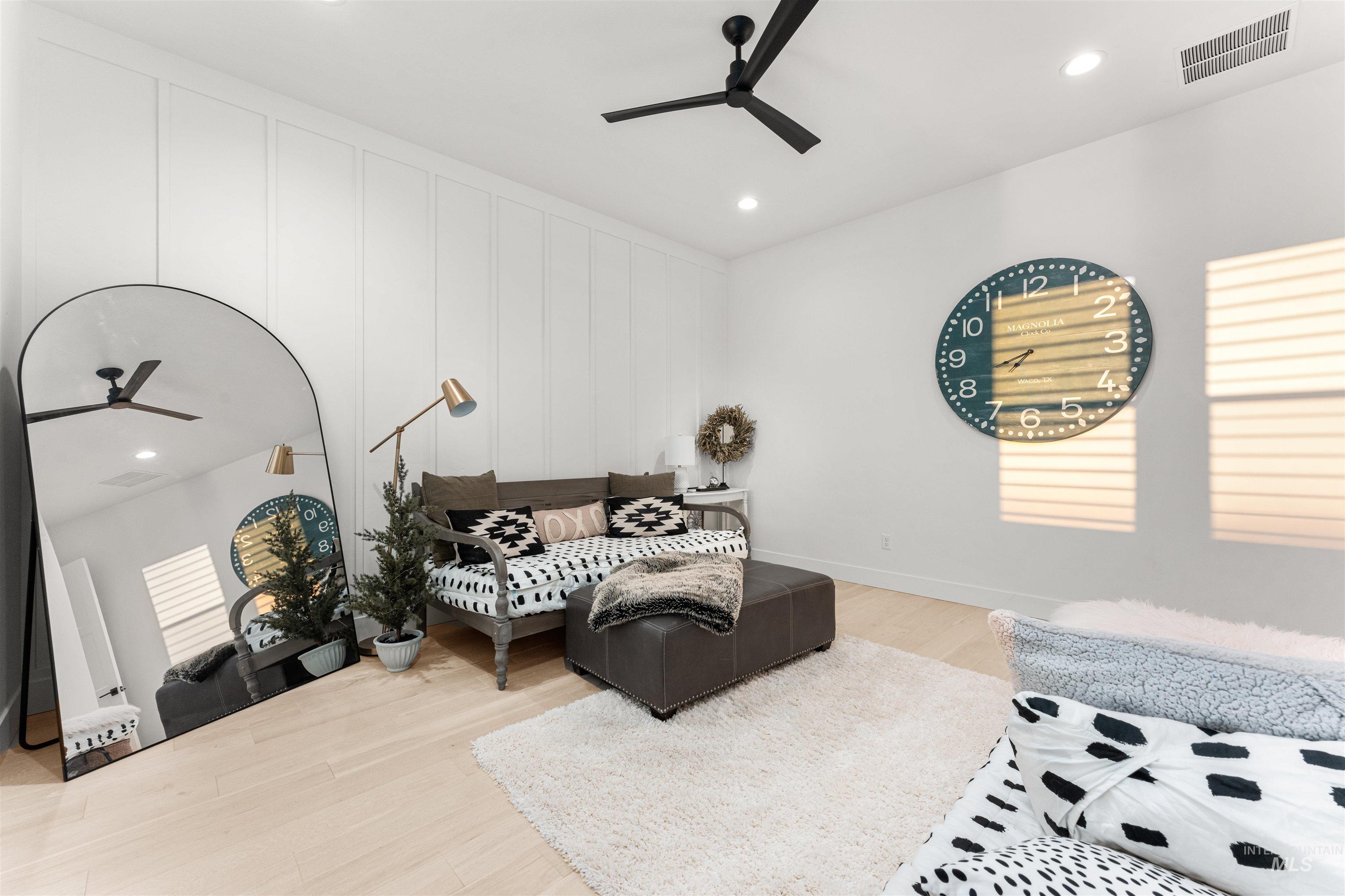 Living room featuring a ceiling fan, recessed lighting, and light wood finished floors