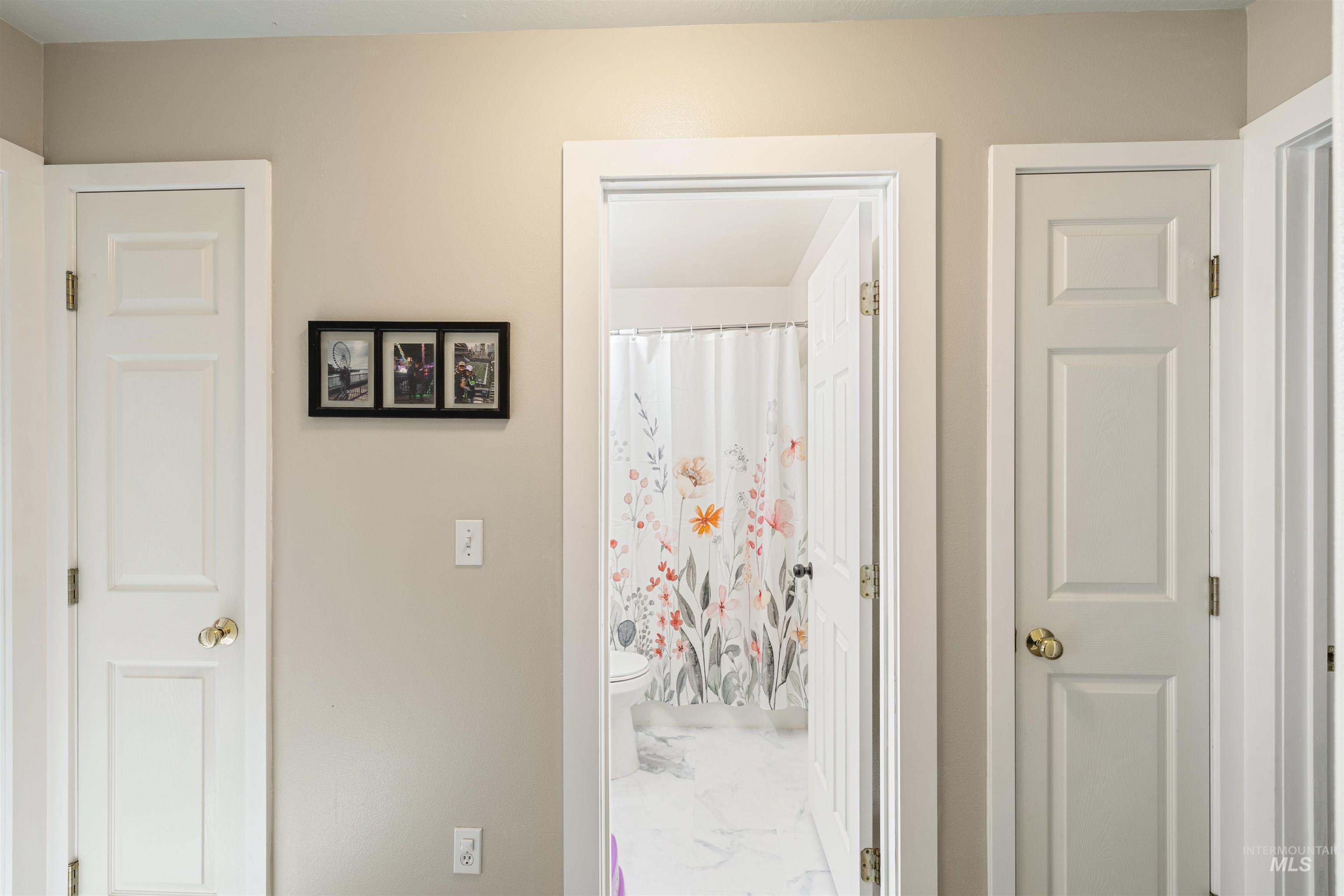 Corridor featuring light marble finish flooring