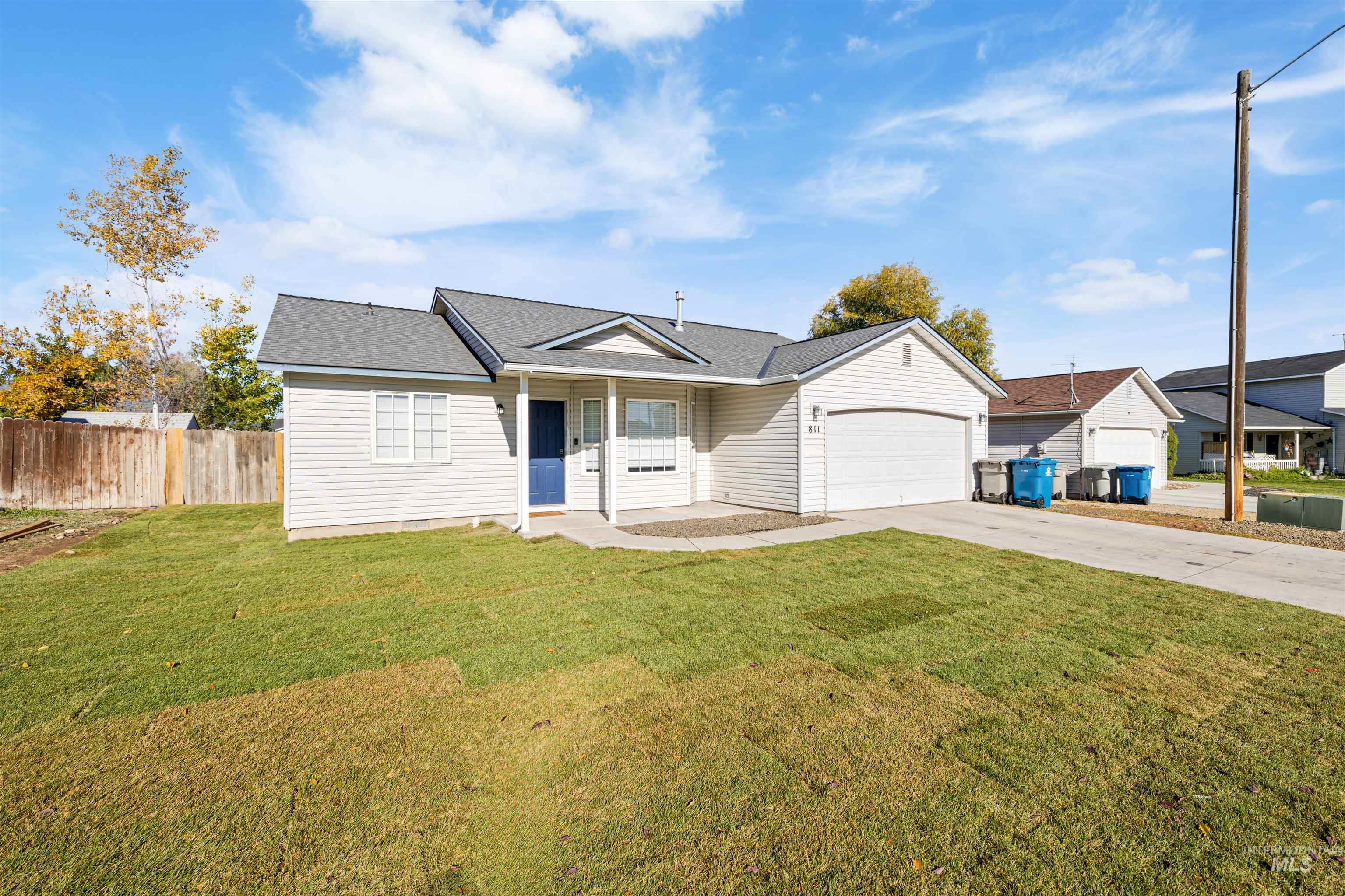 Ranch-style home featuring driveway, covered porch, a shingled roof, and a garage