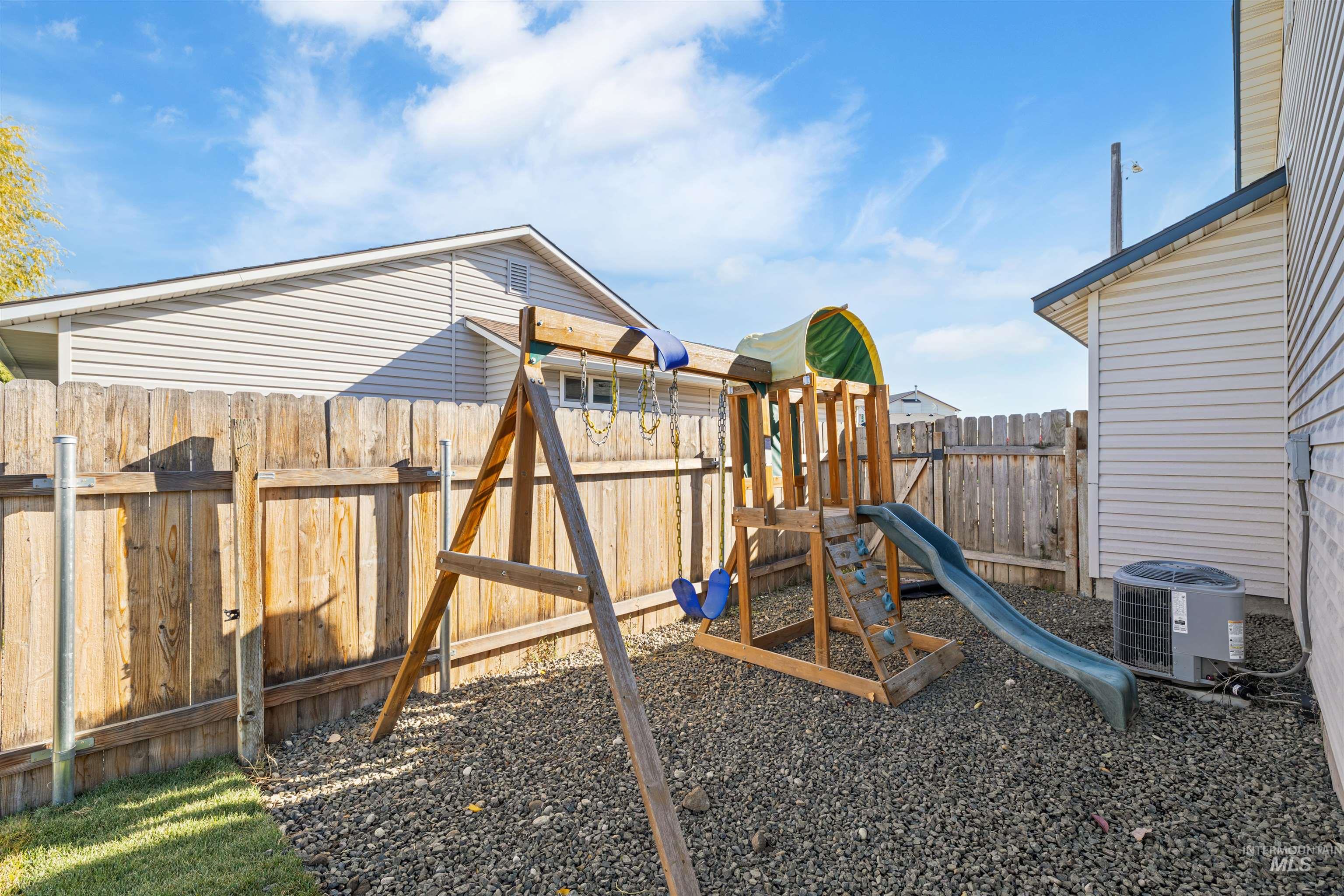 View of jungle gym featuring a fenced backyard