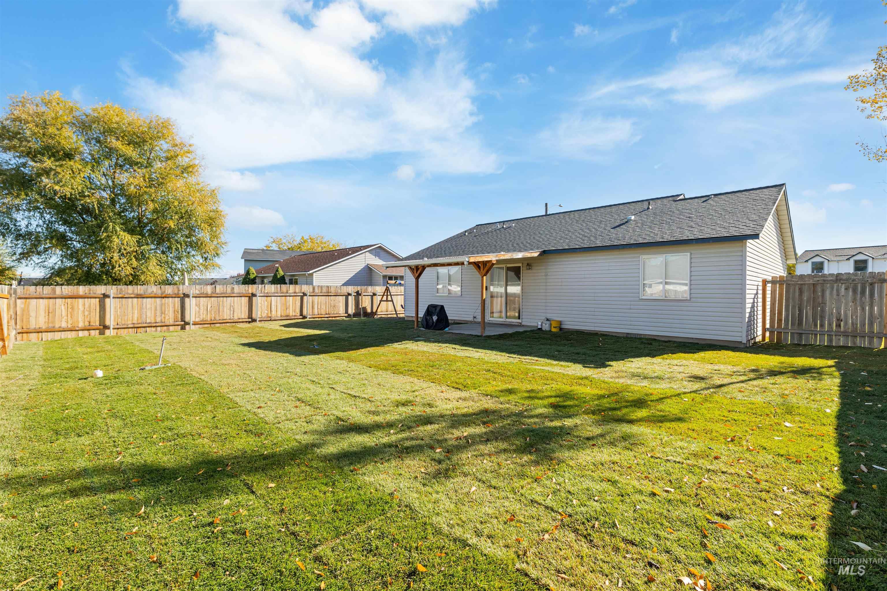 Rear view of property featuring a fenced backyard and a patio area