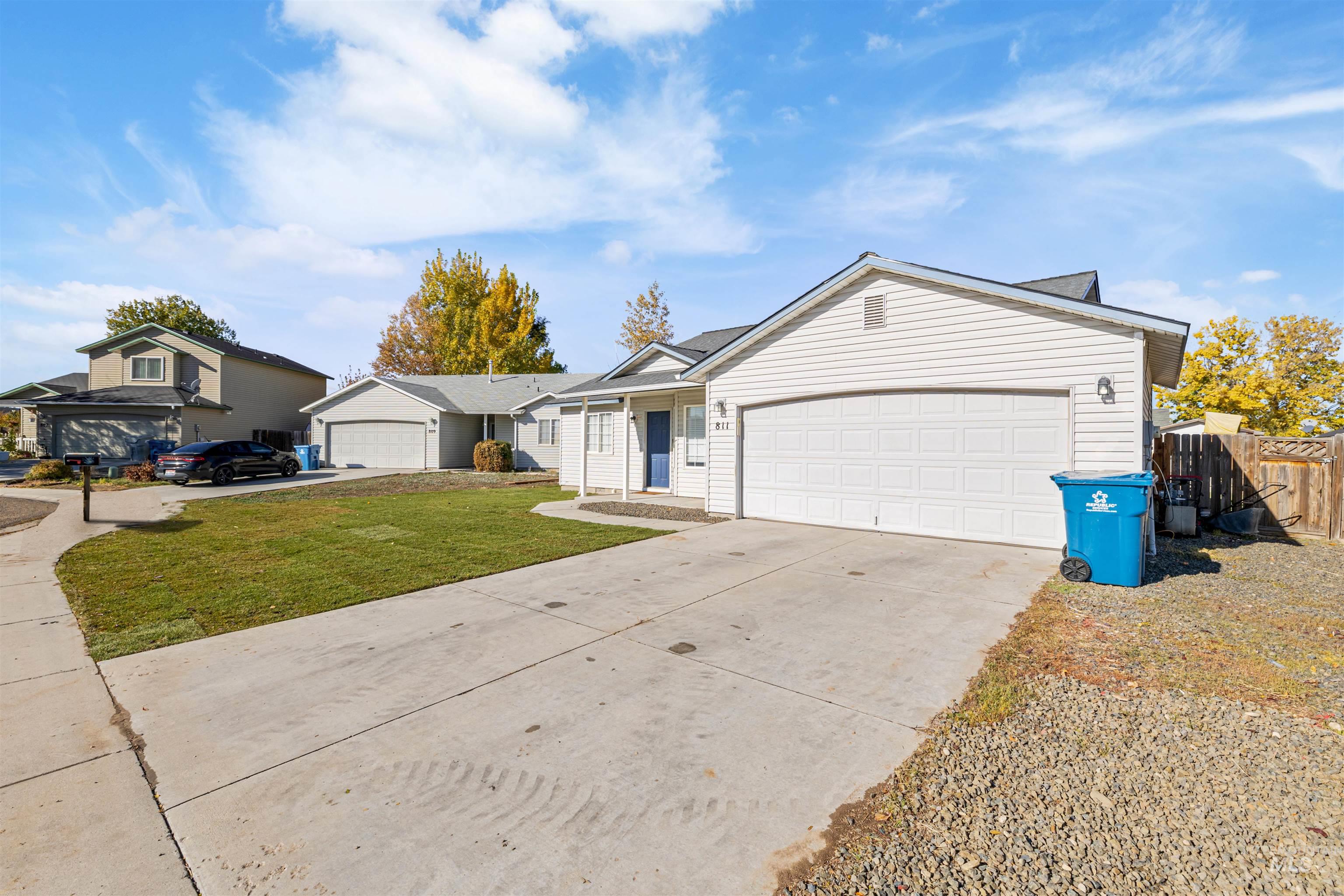 Ranch-style home featuring concrete driveway and an attached garage