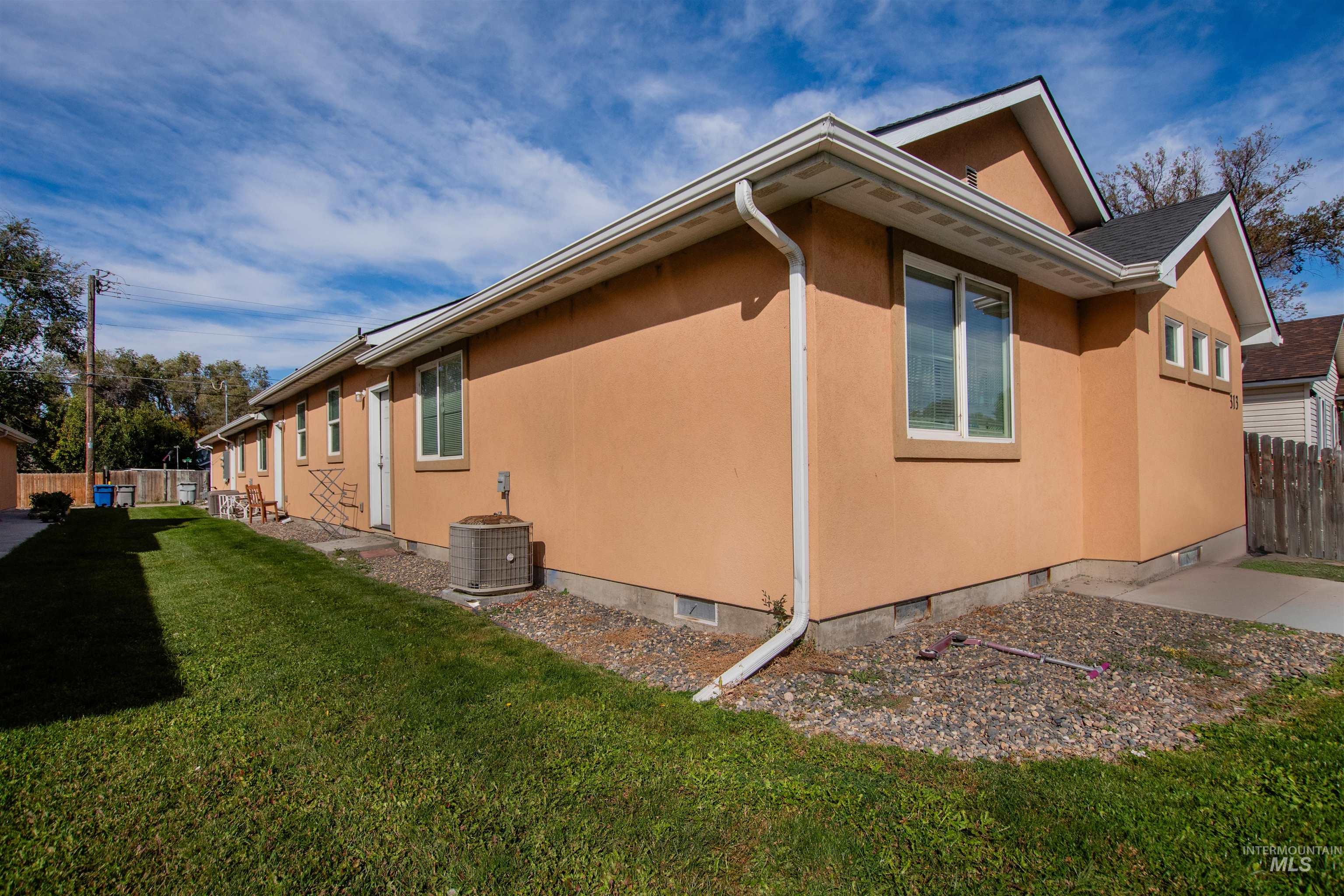 View of side of property with crawl space and stucco siding