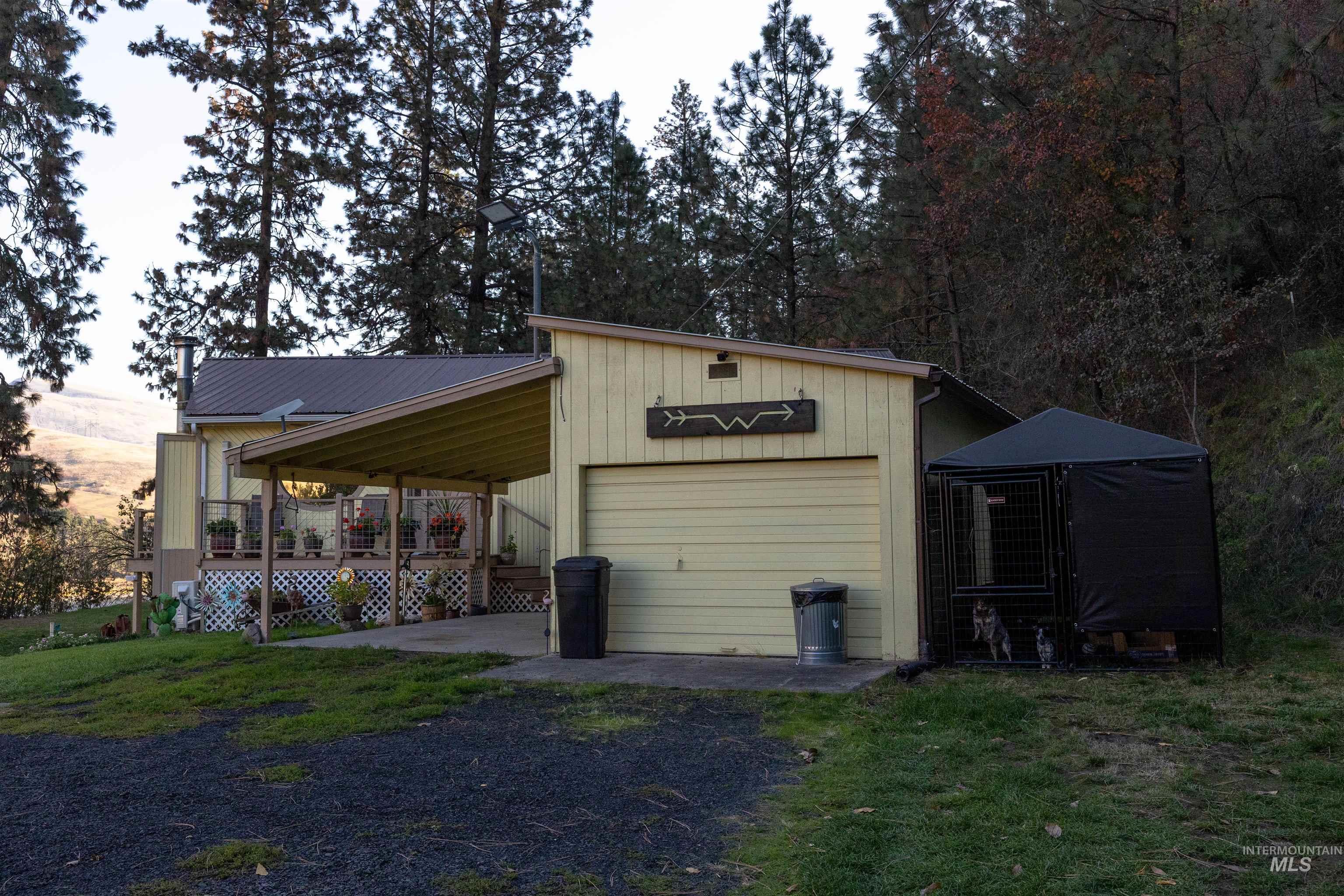 Garage featuring driveway and a garage
