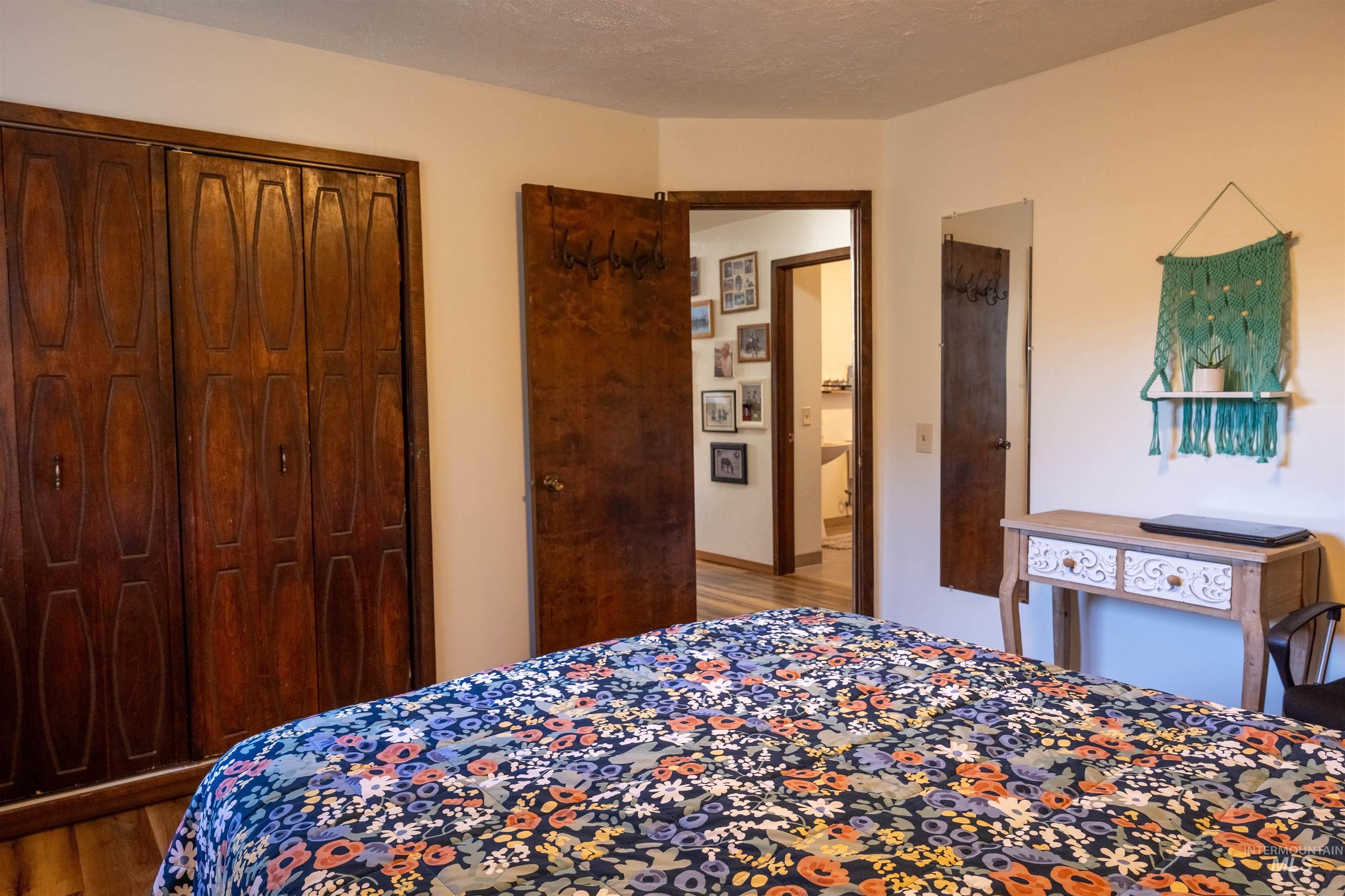 Bedroom featuring light wood-style flooring, a closet, and a textured ceiling
