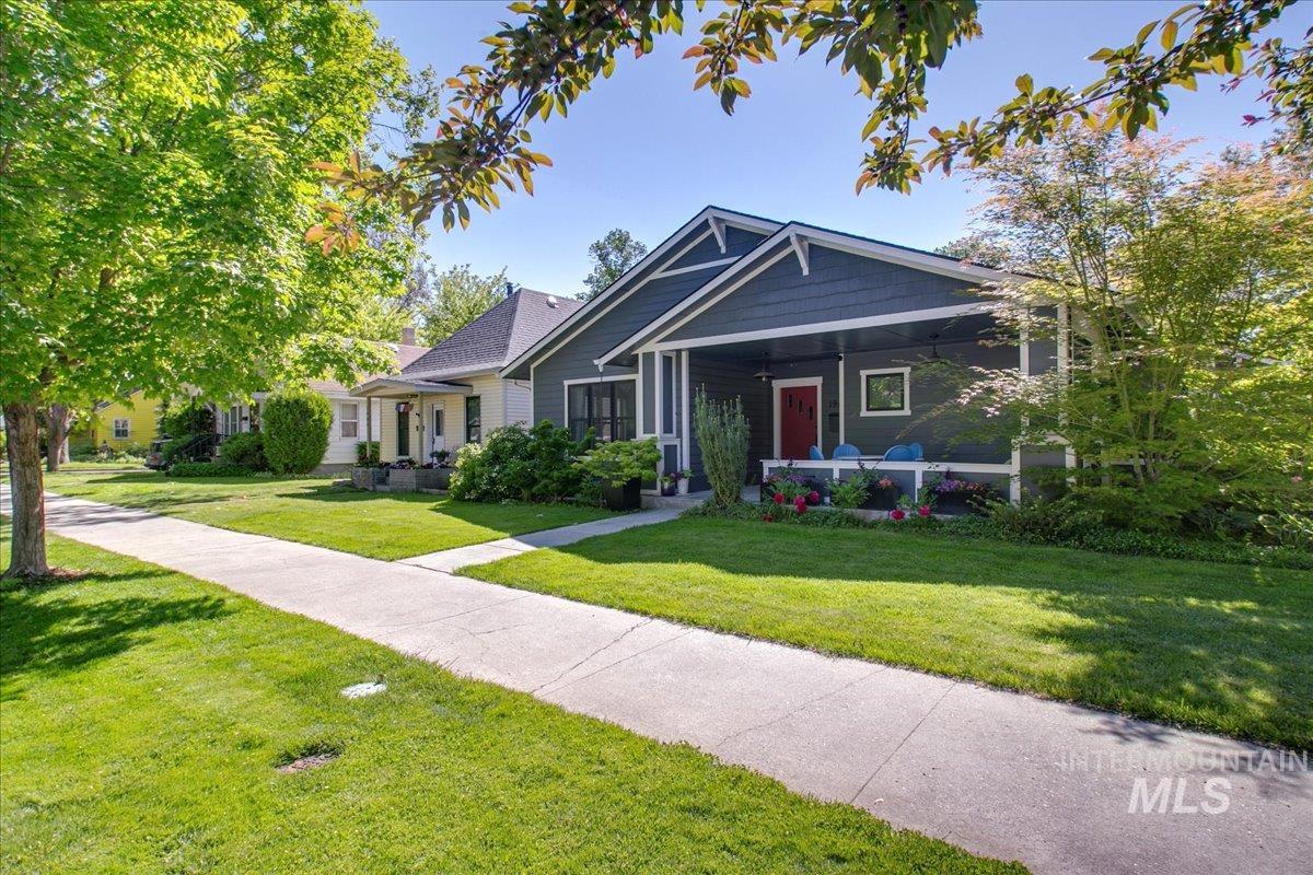 View of front of house featuring covered porch and a front lawn