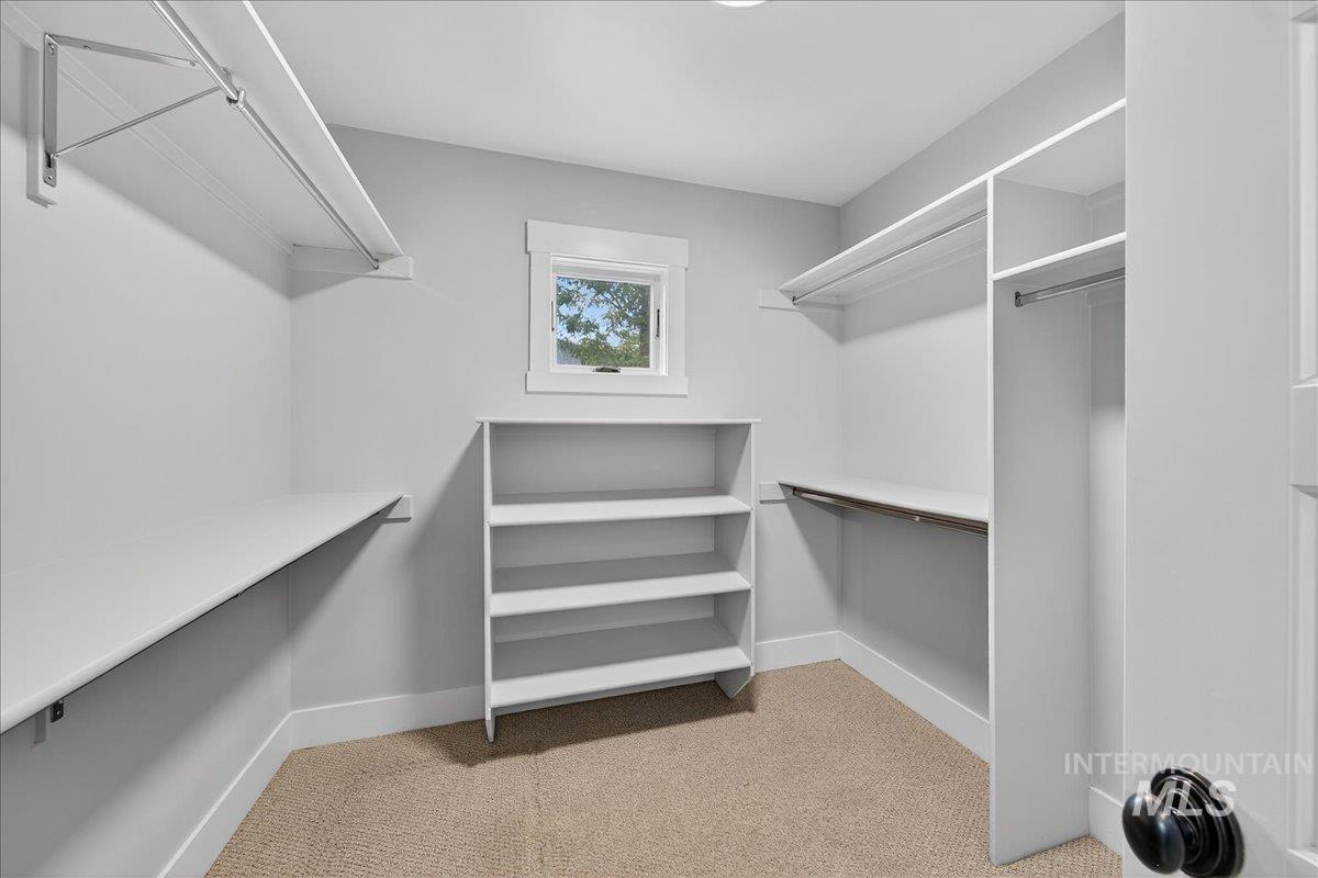 Walk in closet with light carpet