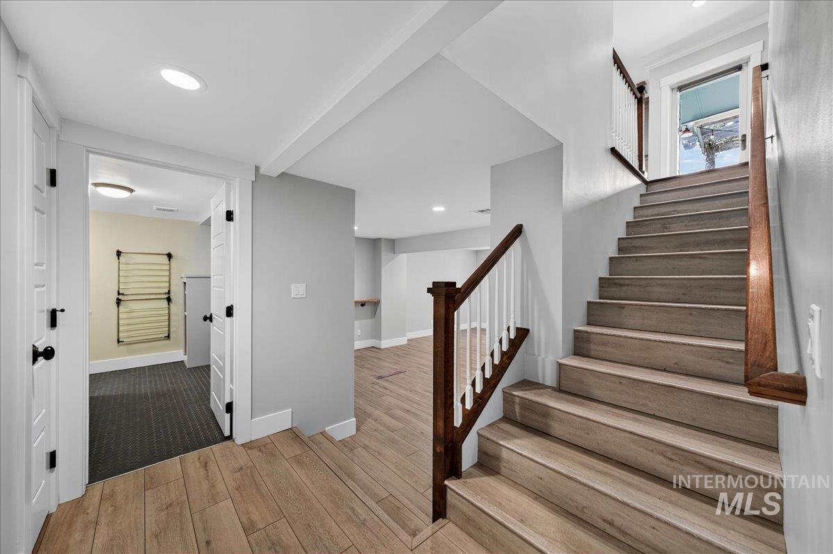 Stairway featuring recessed lighting and wood finished floors