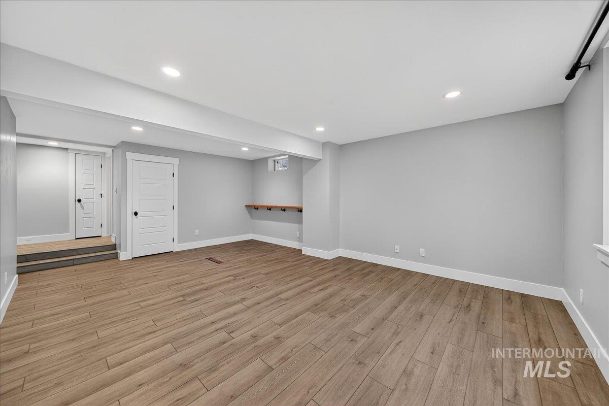 Below grade area featuring recessed lighting and light wood-style flooring