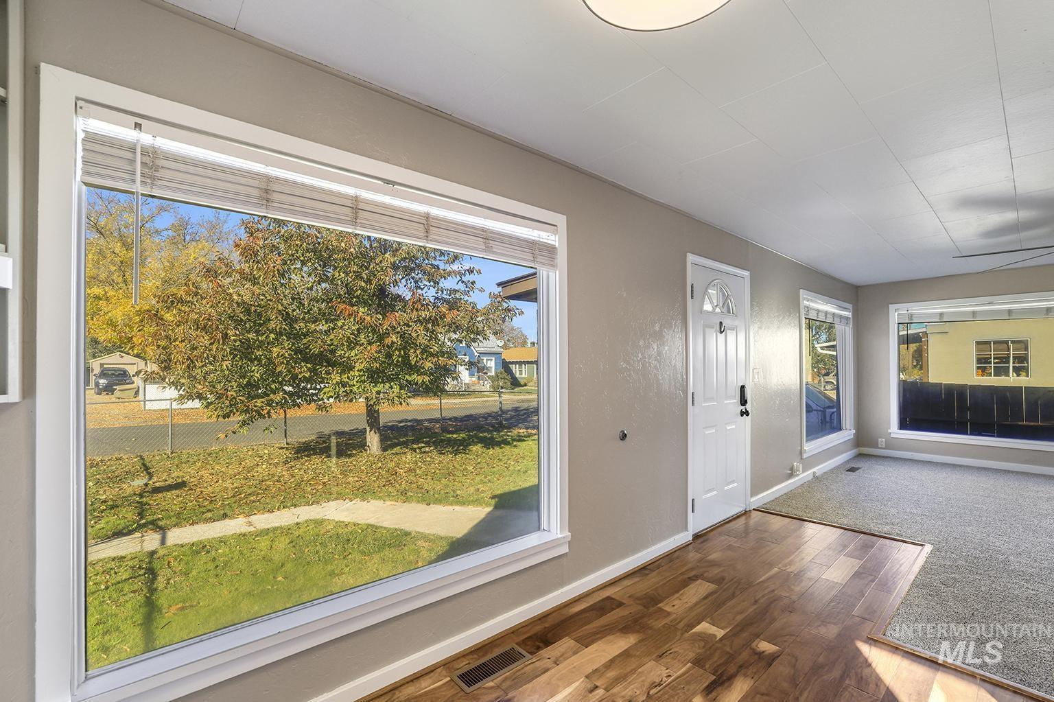 Entrance foyer with wood finished floors and baseboards