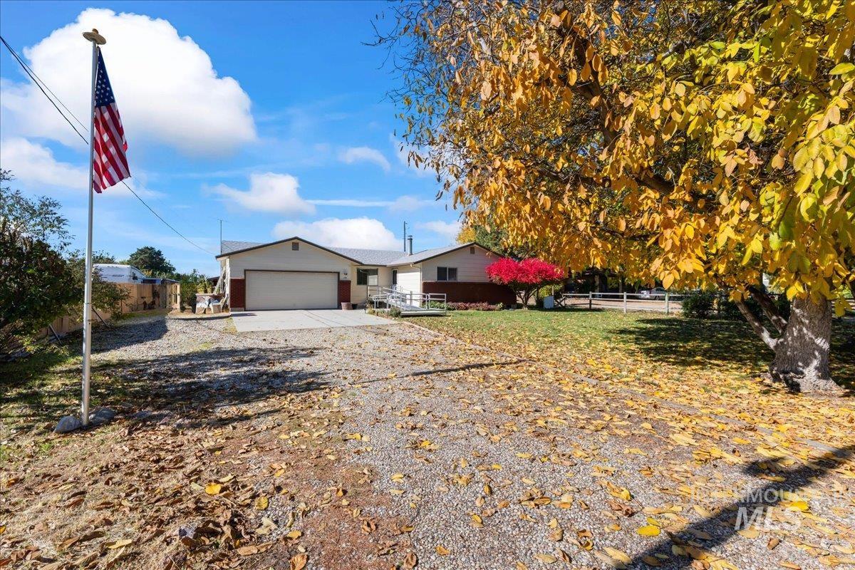 Ranch-style home featuring driveway and a garage