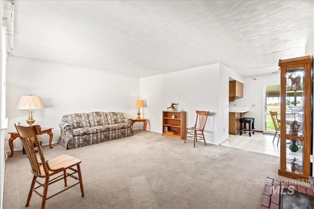 Living area featuring light colored carpet