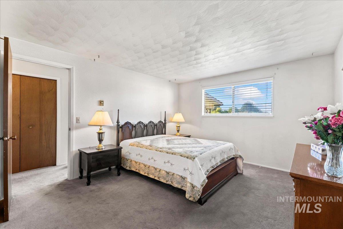 Carpeted bedroom featuring baseboards