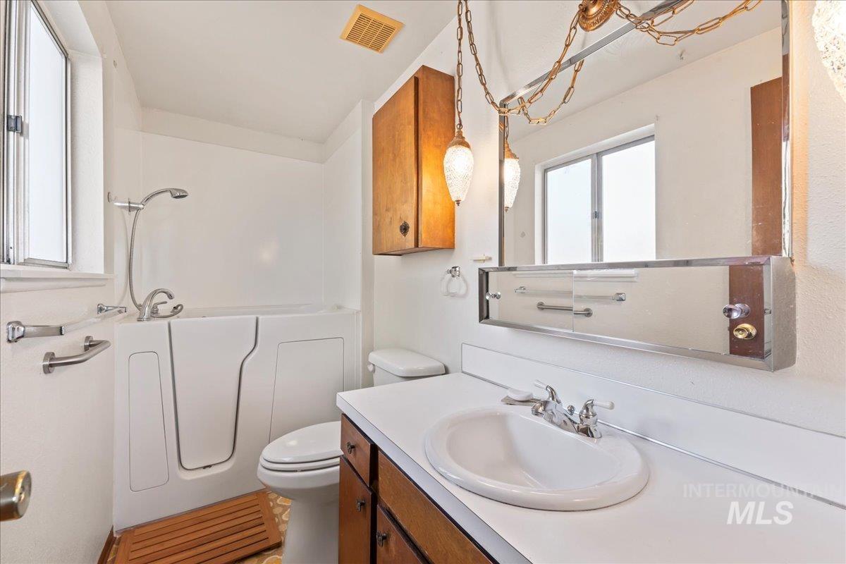 Bathroom with vanity and  shower combination