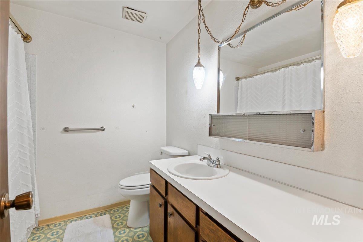 Bathroom with vanity and curtained shower