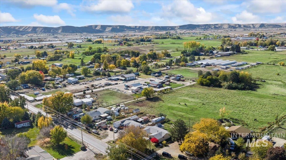 Aerial view of property's location with a mountain backdrop and nearby suburban area