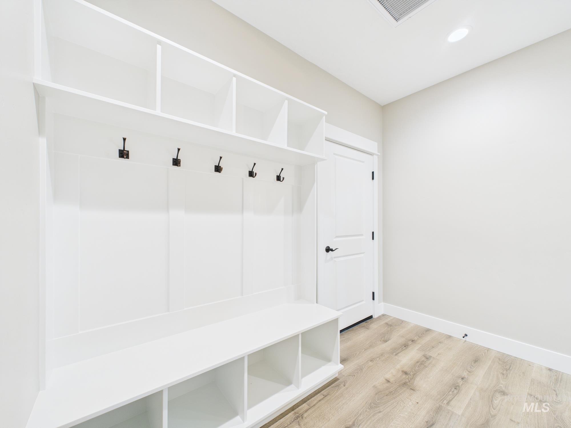 Mudroom with wood finished floors and recessed lighting
