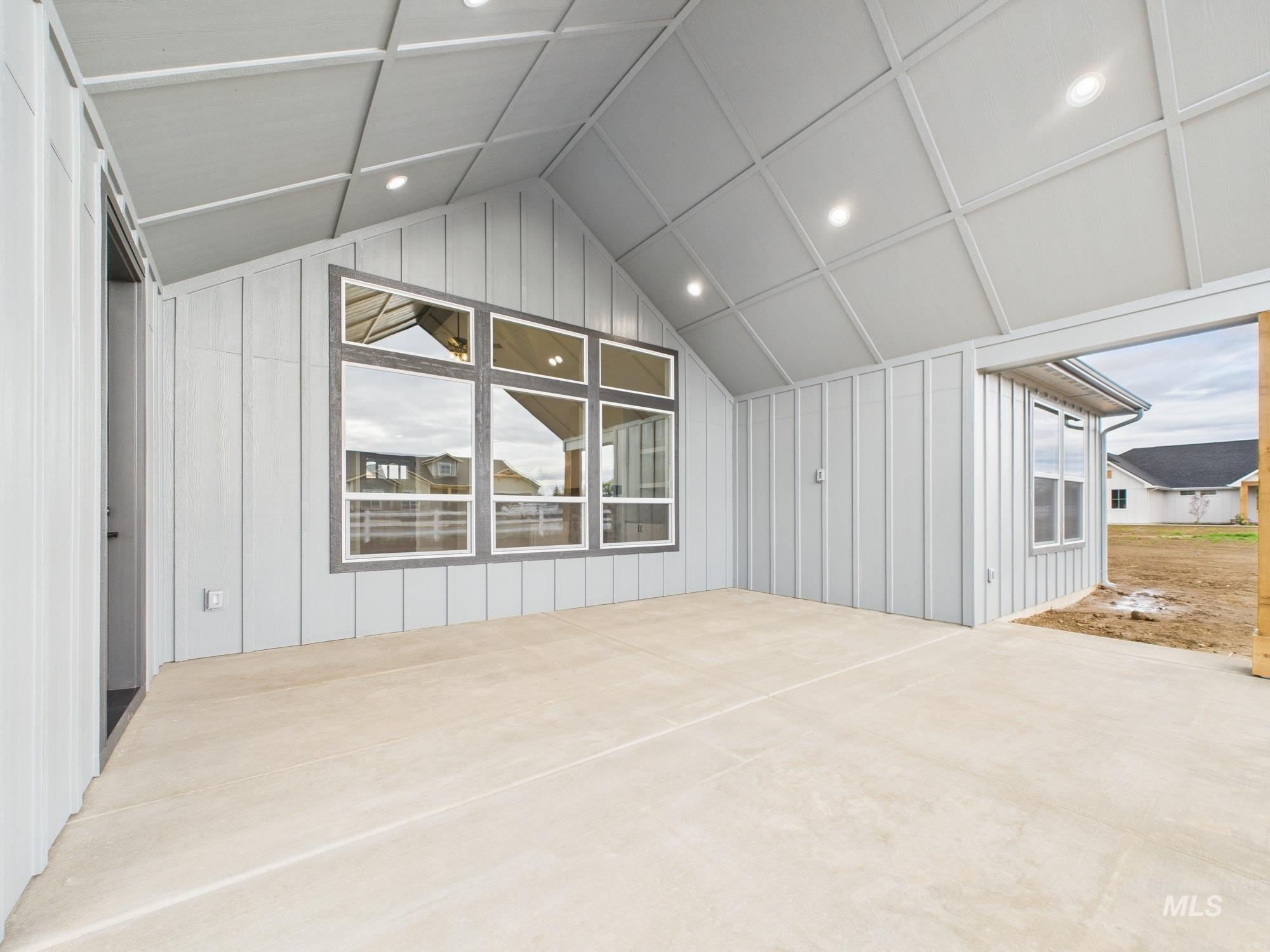 Additional living space featuring vaulted ceiling, recessed lighting, and a decorative wall