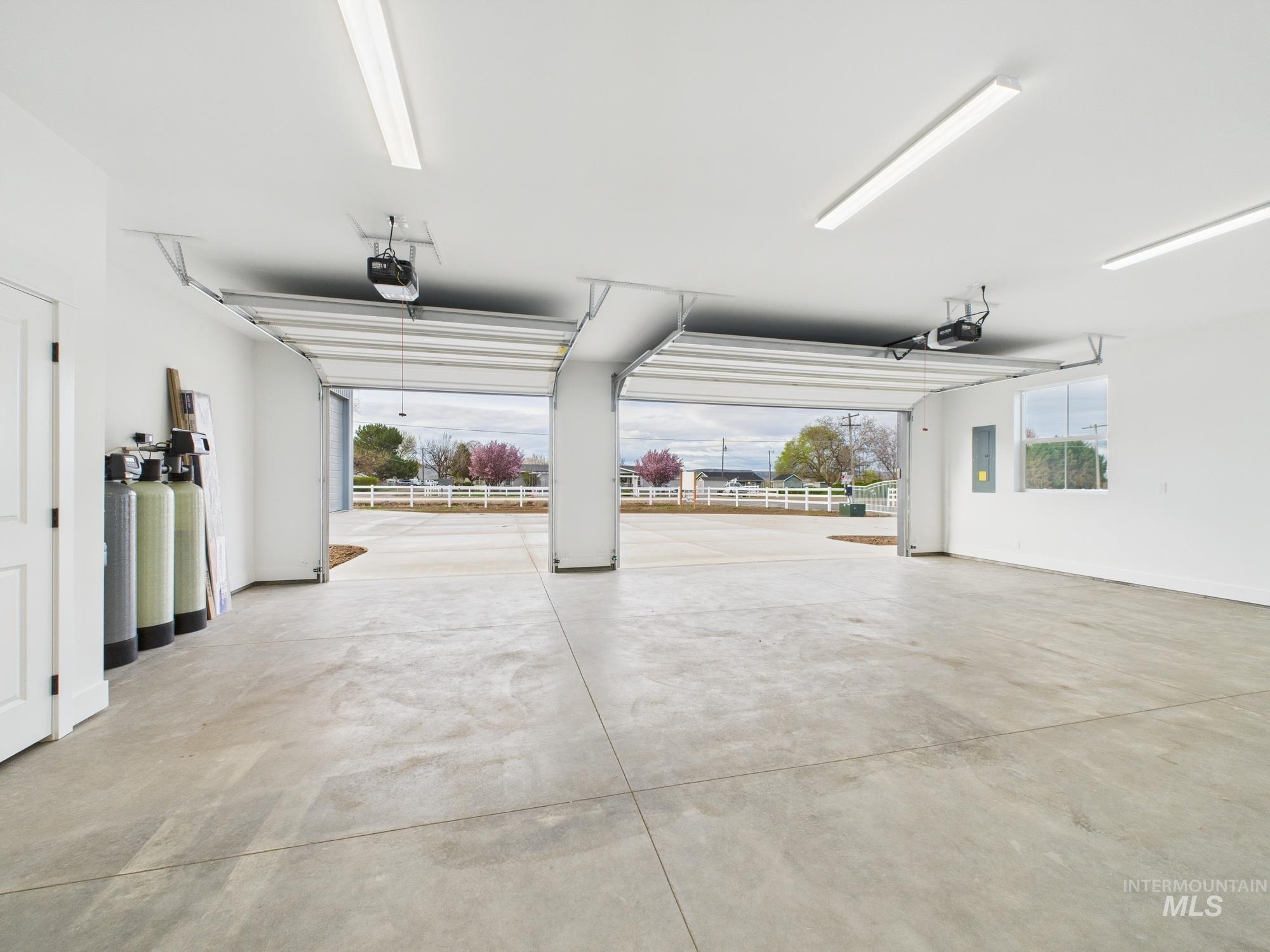 Garage with electric panel and a garage door opener