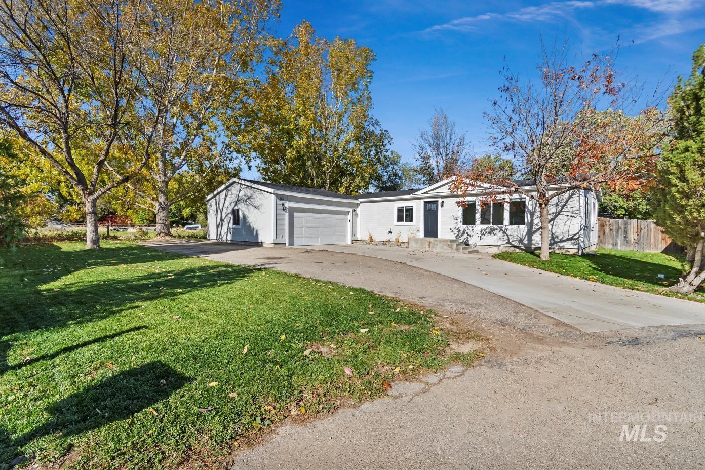 View of front facade featuring concrete driveway and a garage