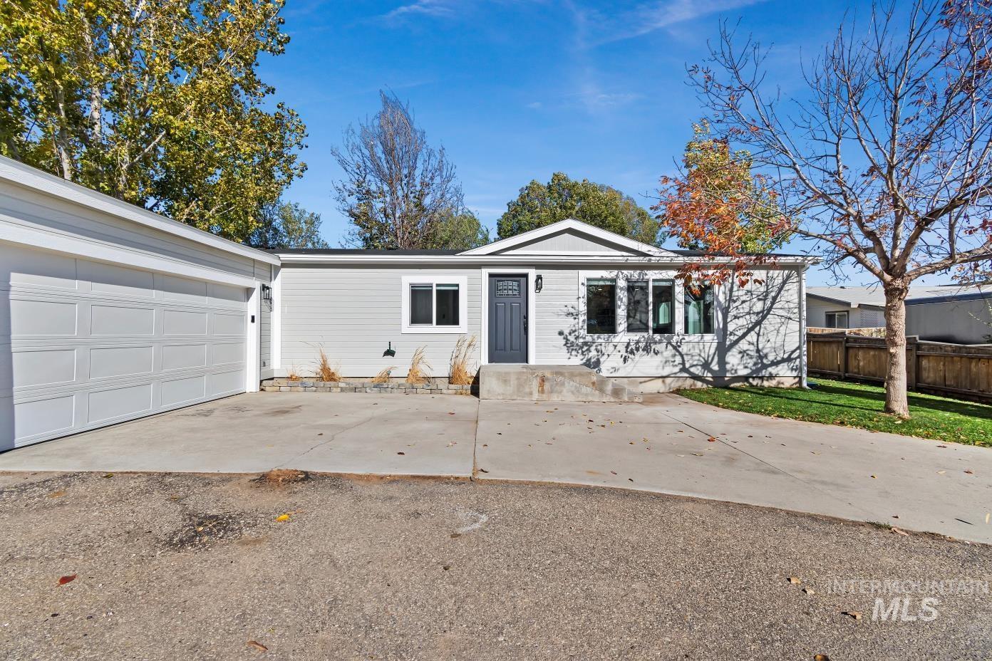 Ranch-style house featuring driveway and a garage