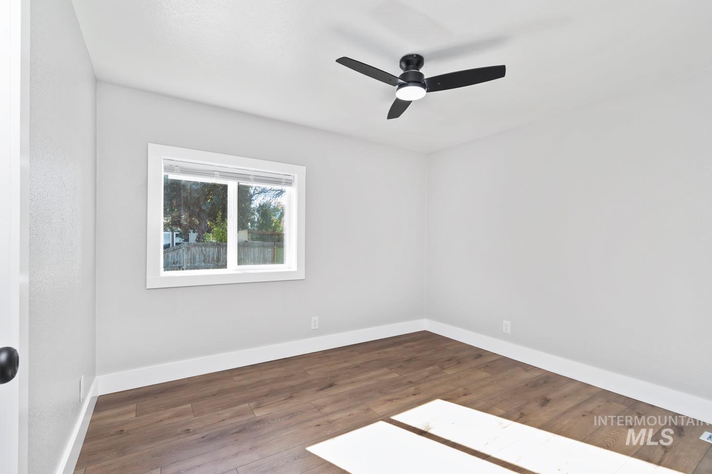 Unfurnished room with wood finished floors and ceiling fan