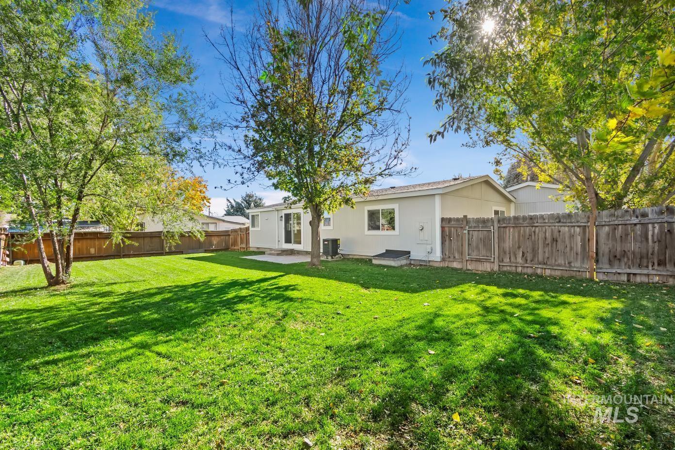 Fenced backyard featuring a patio