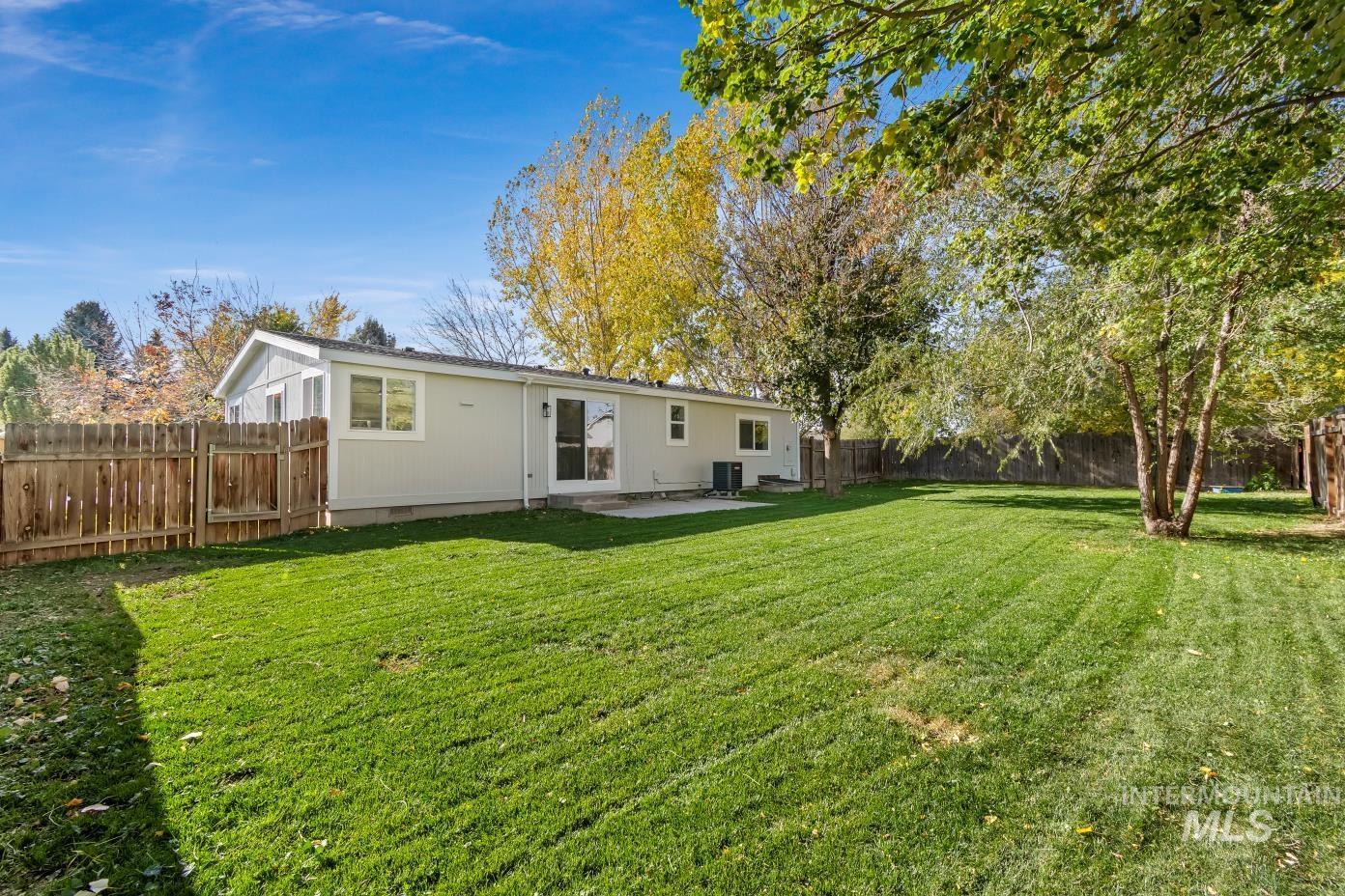 Rear view of property featuring a patio area and a fenced backyard