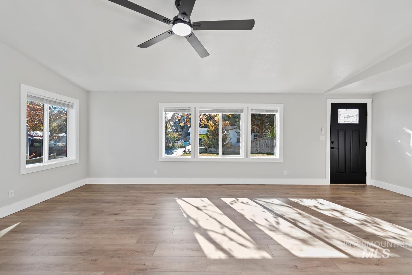 Entryway with wood finished floors and a ceiling fan