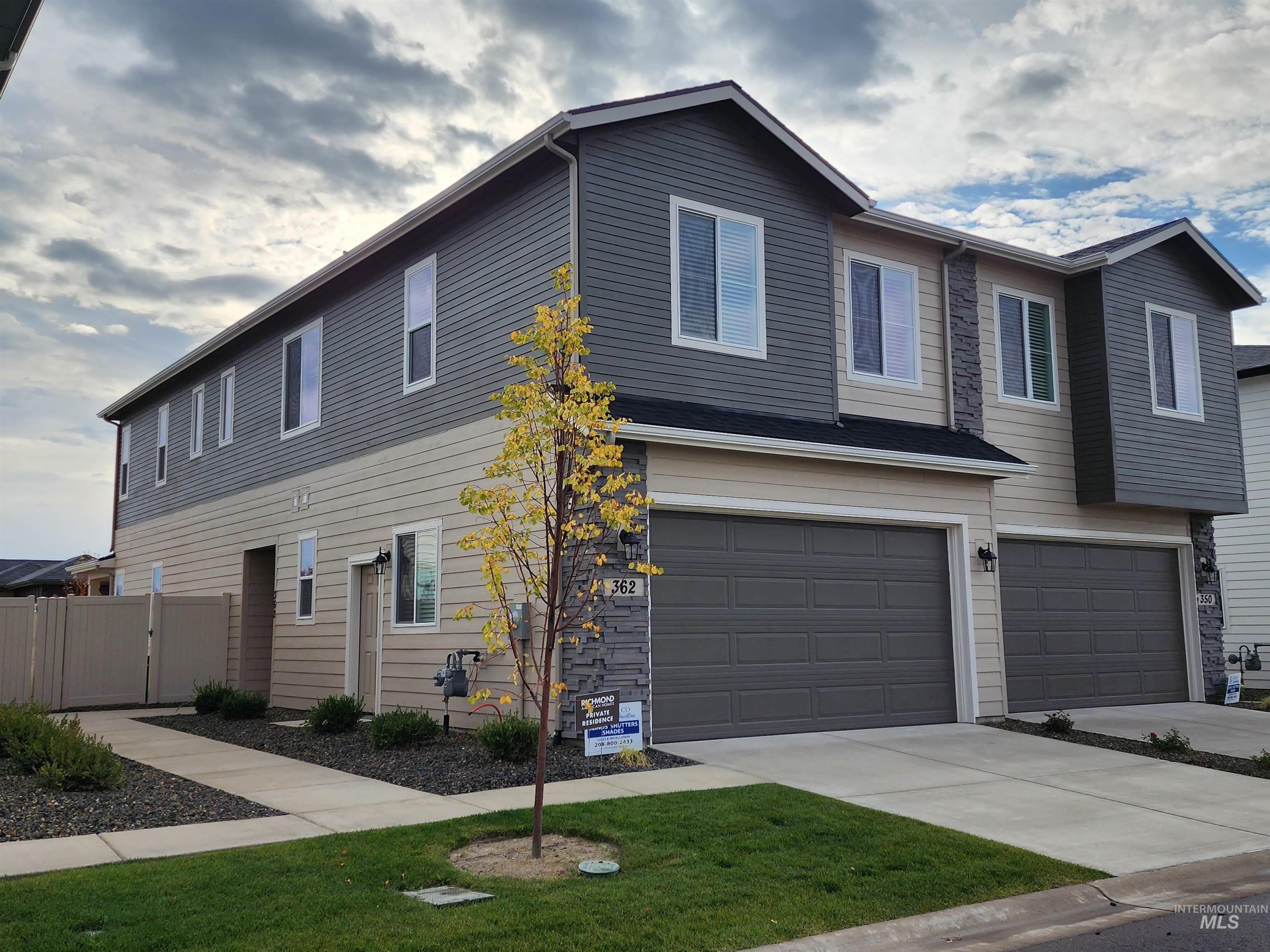 View of front facade featuring an attached garage and driveway